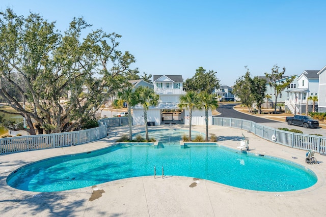 pool featuring a patio area, a residential view, and fence