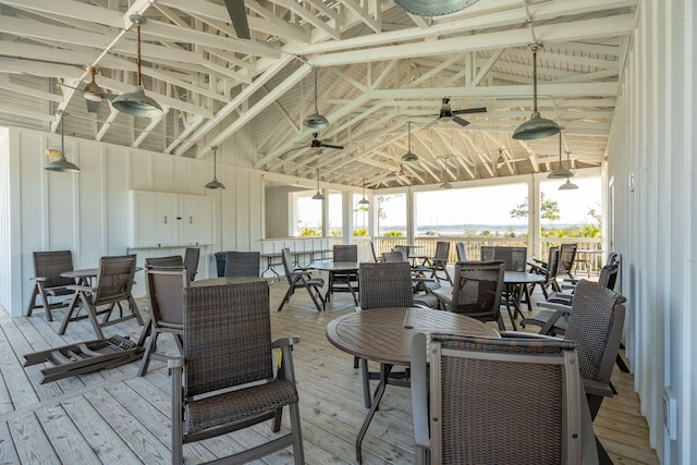 wooden deck featuring outdoor dining area and a ceiling fan