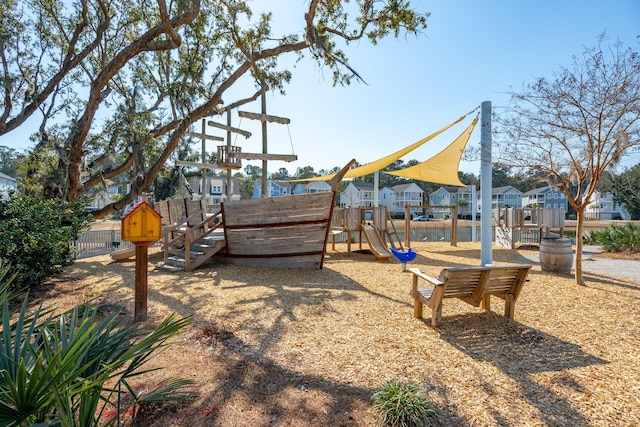 community jungle gym featuring a residential view and fence