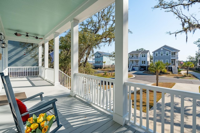 wooden deck featuring a porch and a residential view