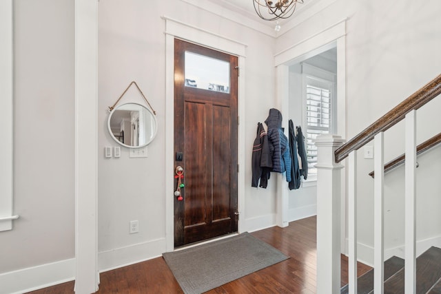 entryway with stairs, baseboards, and wood finished floors