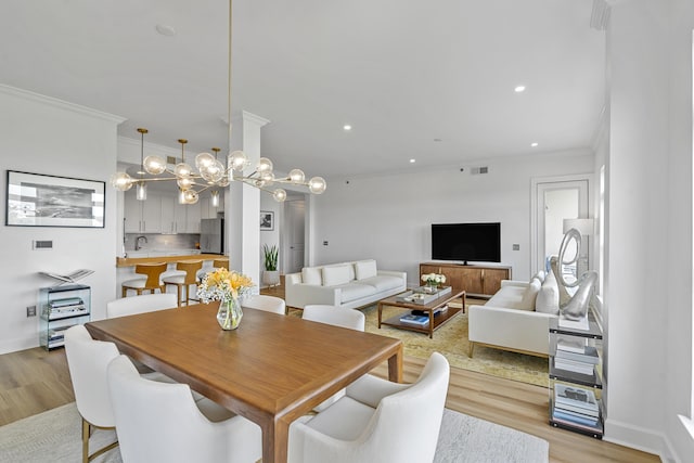 145 Pier View St Unit 407, Charleston, SC 29492 - dining area with crown molding, light wood finished floors, recessed lighting, and a chandelier