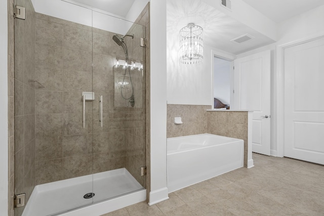 145 Pier View St Unit 407, Charleston, SC 29492 - bathroom featuring a bath, a shower stall, and a chandelier