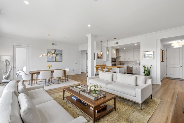 145 Pier View St Unit 407, Charleston, SC 29492 - living area featuring crown molding, a chandelier, light wood-style floors, baseboards, and recessed lighting