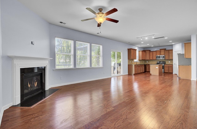 123 Blackwater Way, Moncks Corner, SC 29461 - unfurnished living room with a ceiling fan, dark wood-type flooring, and a glass covered fireplace