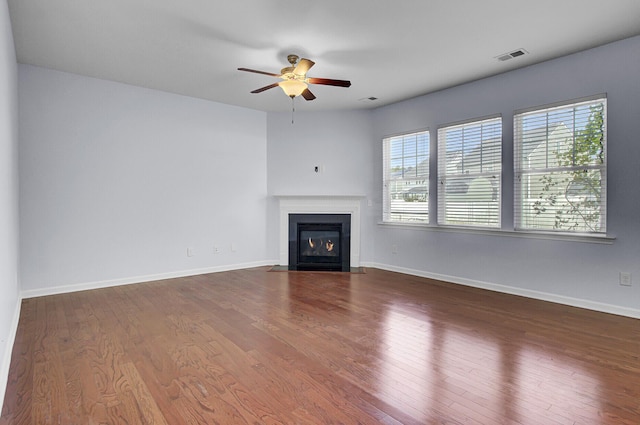 123 Blackwater Way, Moncks Corner, SC 29461 - unfurnished living room featuring plenty of natural light, a ceiling fan, a fireplace with flush hearth, and wood finished floors