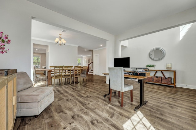 dining space with ornamental molding, baseboards, an inviting chandelier, and wood finished floors