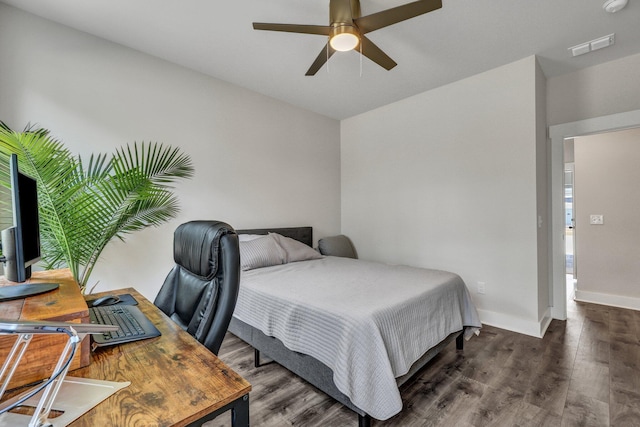 bedroom featuring a ceiling fan, visible vents, wood finished floors, and baseboards