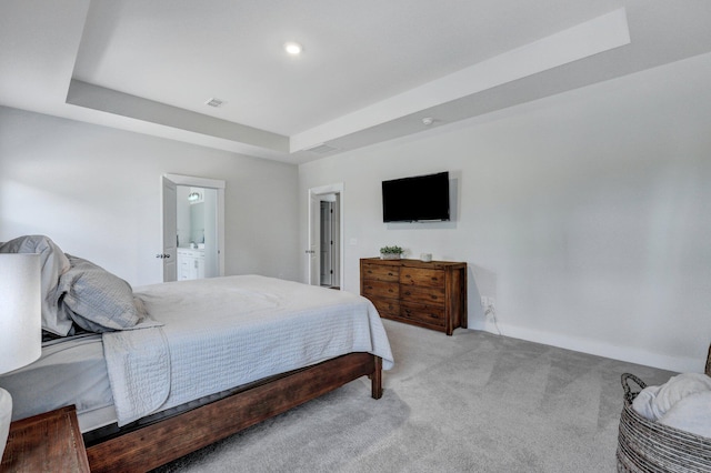 bedroom with visible vents, baseboards, a tray ceiling, and carpet floors