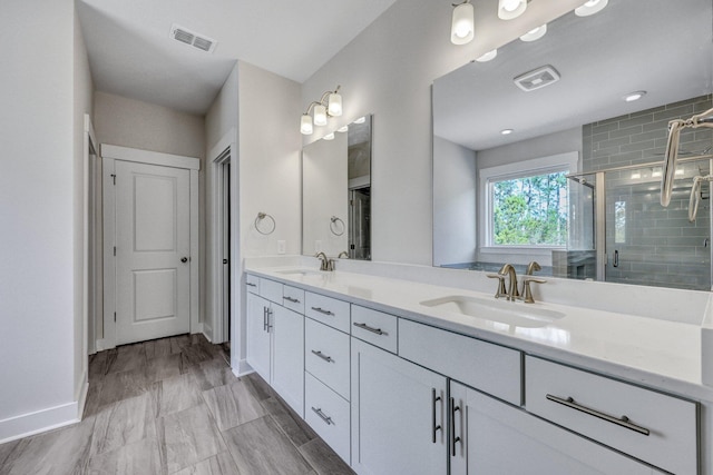 full bath featuring a sink, visible vents, and a stall shower