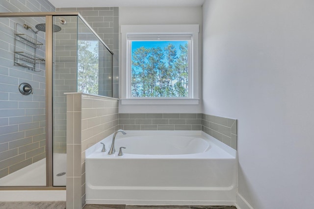 full bath featuring a garden tub and a shower stall