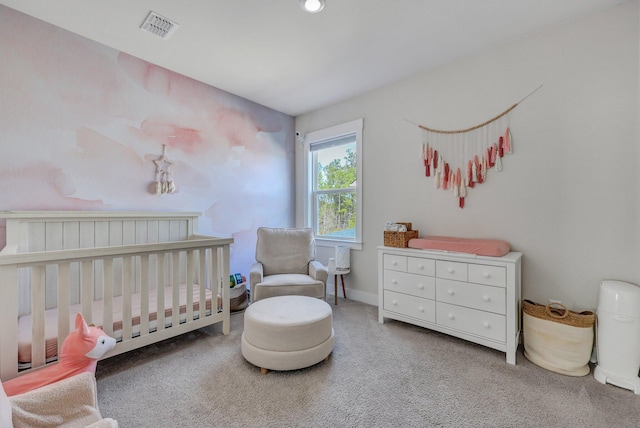 bedroom featuring baseboards, visible vents, a crib, and carpet floors