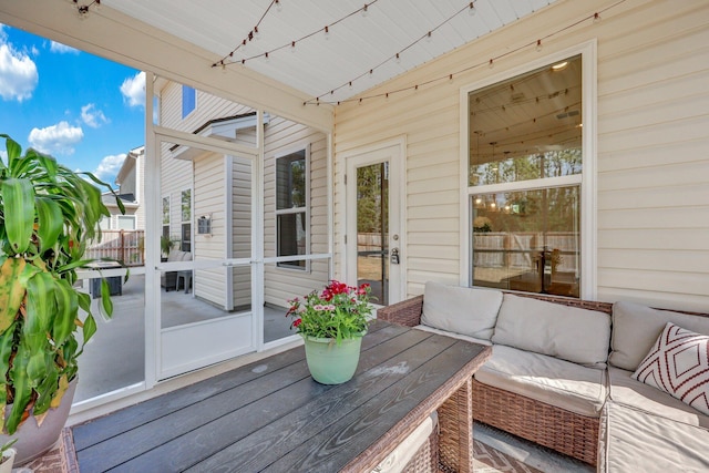 deck featuring outdoor lounge area and fence