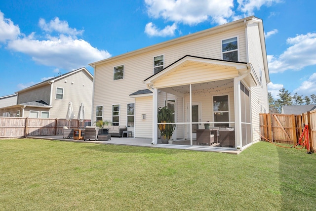 rear view of house featuring a patio area, a lawn, a fenced backyard, and a sunroom