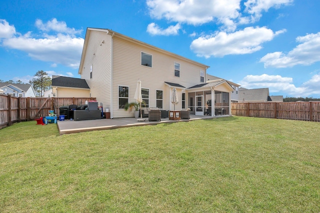 rear view of house with a yard, a patio, a fenced backyard, and a sunroom