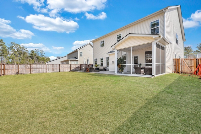 back of property featuring a yard, a fenced backyard, and a sunroom