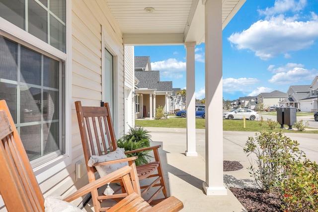 view of patio featuring covered porch and a residential view