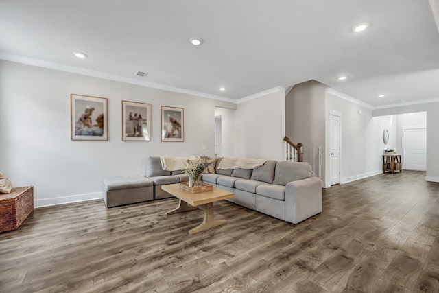 living area with stairway, baseboards, visible vents, and wood finished floors