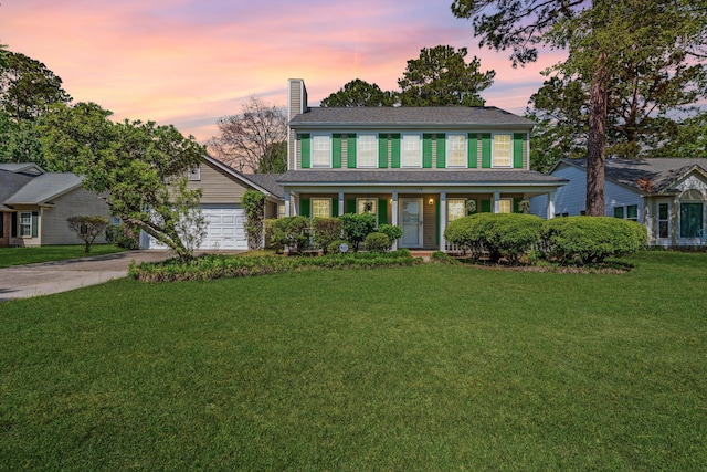 119 Alwyn Blvd, Summerville, SC 29485 - colonial home with a chimney, concrete driveway, a porch, a lawn, and a garage