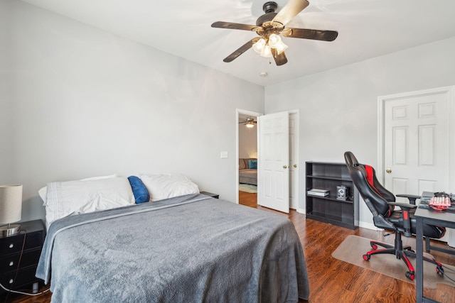 bedroom with baseboards, a ceiling fan, and dark wood-style flooring