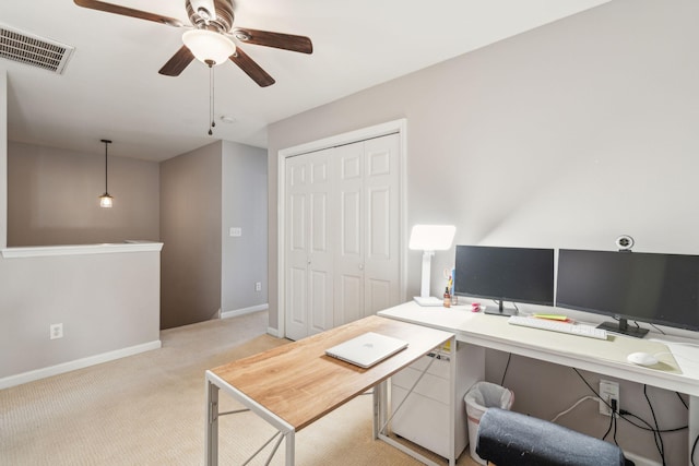 office area featuring visible vents, light carpet, baseboards, and a ceiling fan