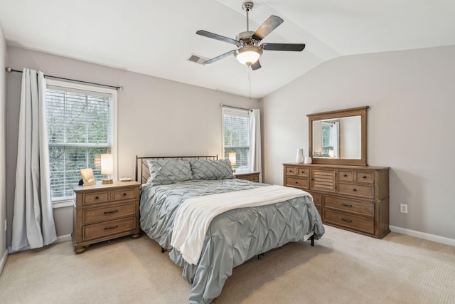 bedroom featuring light carpet, visible vents, multiple windows, and lofted ceiling