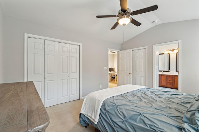 bedroom with two closets, a ceiling fan, connected bathroom, lofted ceiling, and light colored carpet