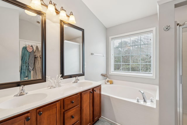 bathroom with a bath, double vanity, and a sink