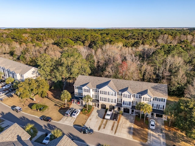 birds eye view of property featuring a wooded view