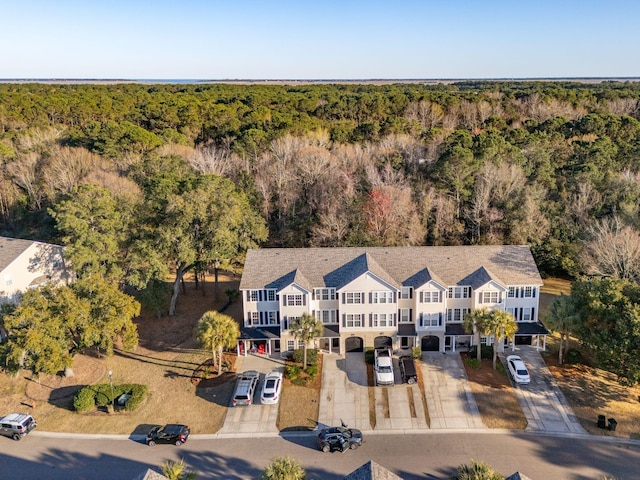 bird's eye view with a wooded view