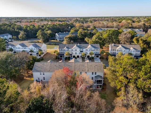 birds eye view of property featuring a wooded view and a residential view