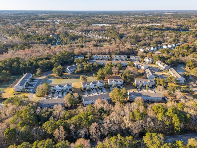 bird's eye view featuring a residential view and a wooded view