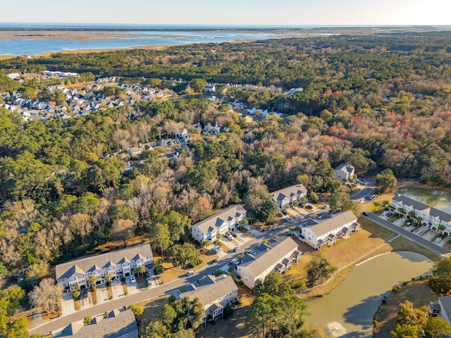 drone / aerial view featuring a forest view and a water view