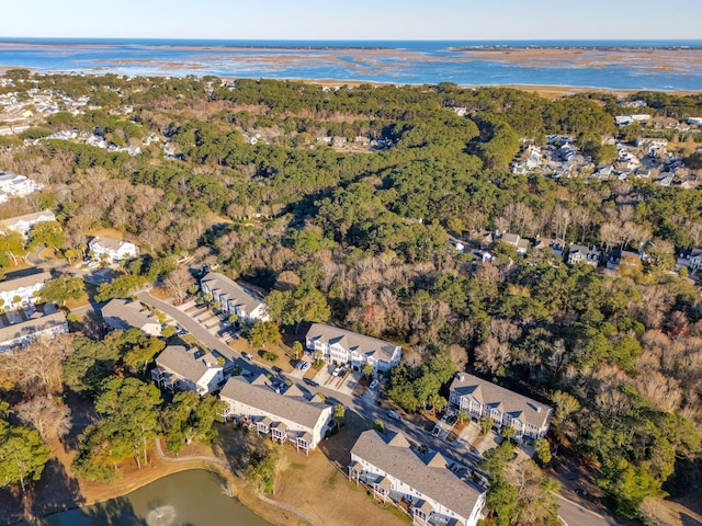 drone / aerial view with a residential view, a forest view, and a water view