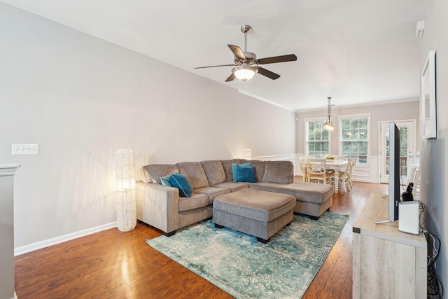 living room featuring hardwood / wood-style flooring, ornamental molding, baseboards, and ceiling fan