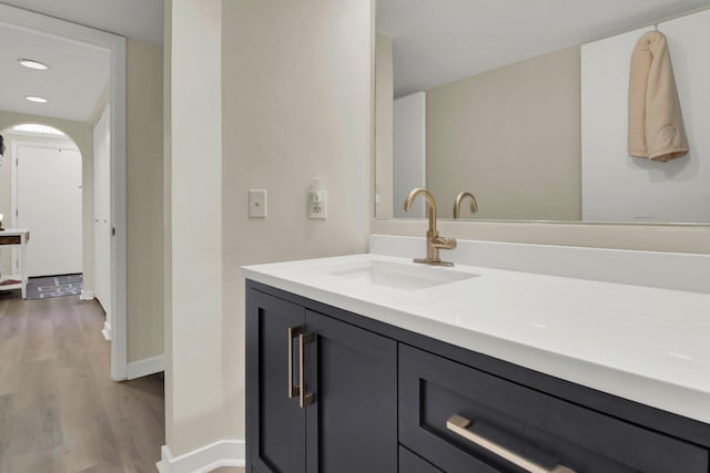 bathroom with vanity and hardwood / wood-style floors