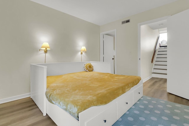 bedroom with wood-type flooring