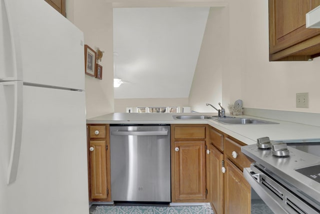 kitchen with appliances with stainless steel finishes, ventilation hood, and sink