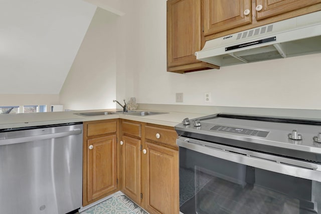 kitchen featuring stainless steel appliances, vaulted ceiling, and sink