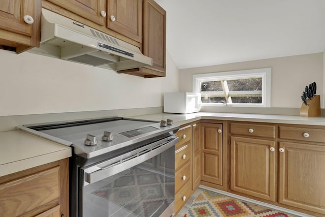 kitchen featuring vaulted ceiling and electric range