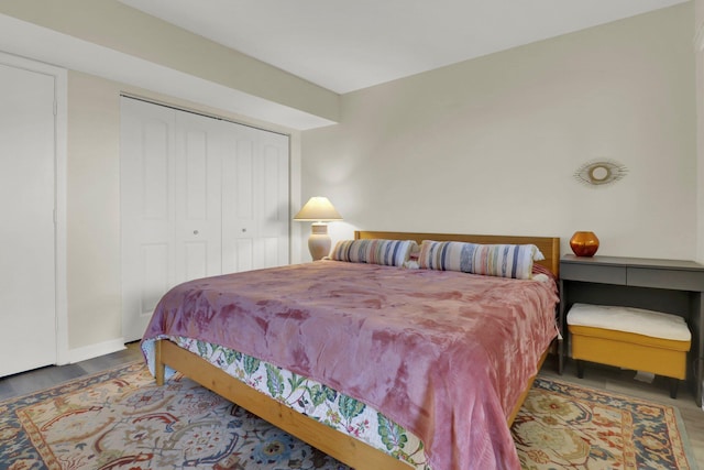 bedroom featuring dark hardwood / wood-style floors and a closet