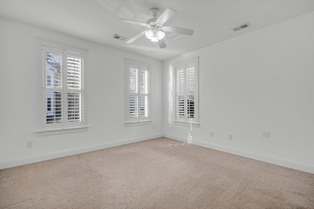 empty room featuring ceiling fan and carpet flooring