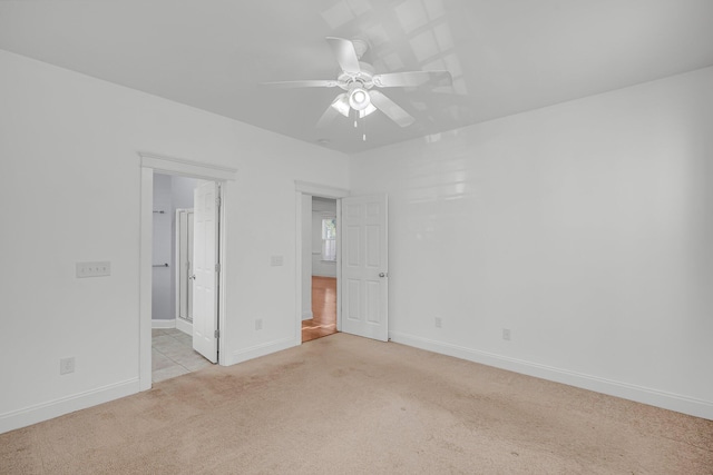 carpeted empty room with ceiling fan