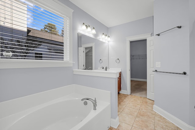 bathroom featuring vanity, a bathtub, and tile patterned flooring