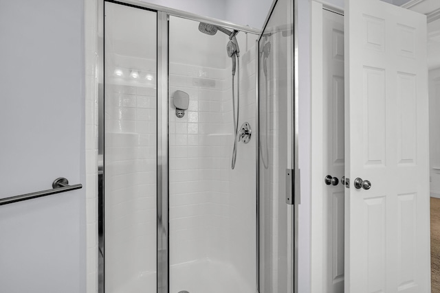 bathroom featuring a shower with door