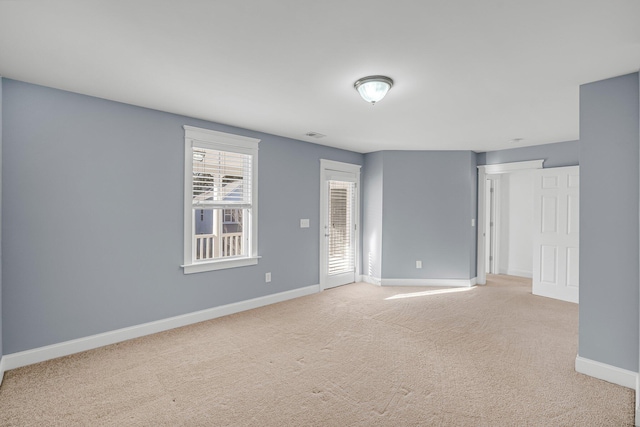 unfurnished room with light colored carpet