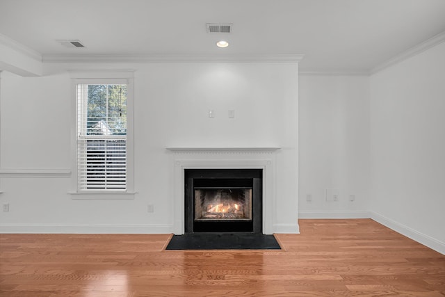 details with hardwood / wood-style floors and crown molding