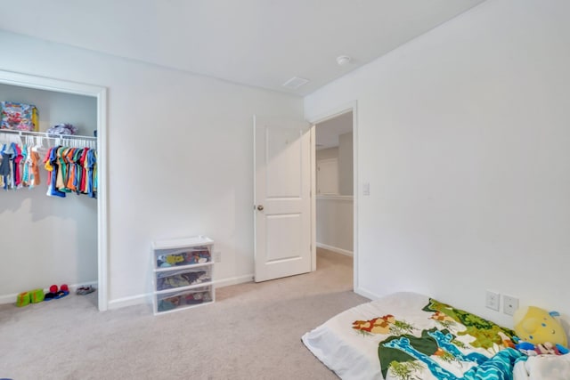 bedroom featuring a closet and light colored carpet