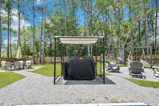 view of home's community featuring a patio and an outdoor living space with a fire pit