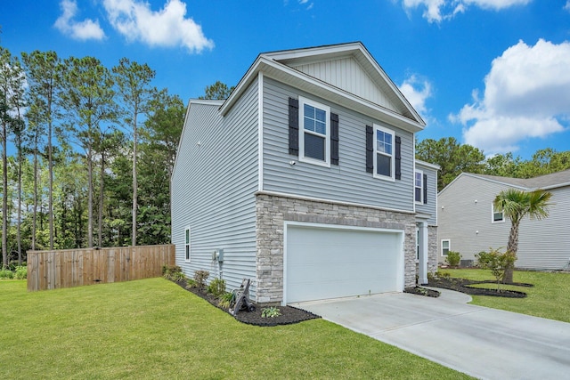 view of front of home with a front yard and a garage